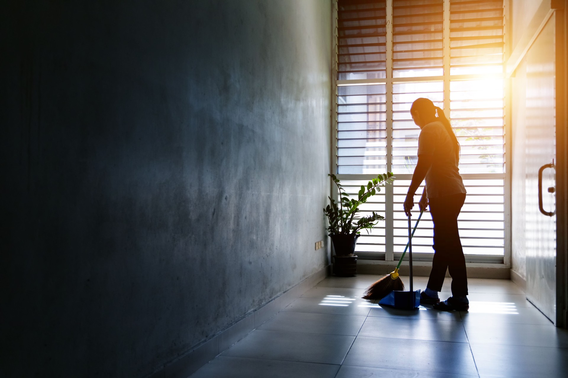 Golden State Cleaning Janitor woman sweep the floor for a client in Murrieta, Ca